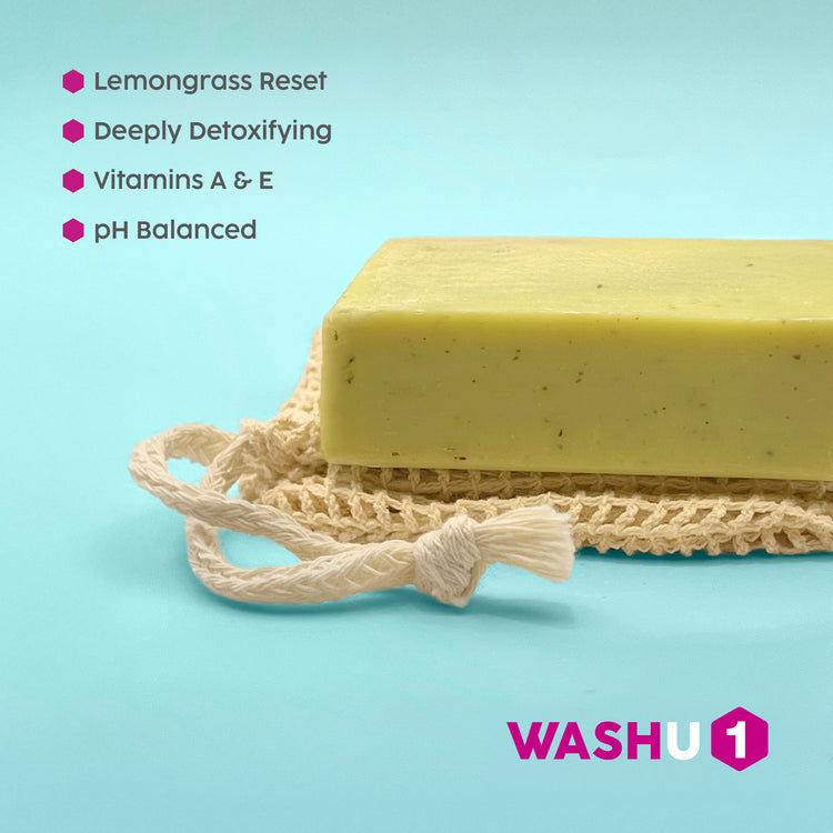 Bar of WashU1 soap on a bamboo cotton wash bag with WASHU branding on a light mint background