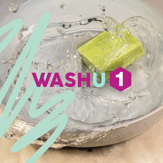 Green washu1 soap bar in a metal bowl with water splashing and 'WASHU' branding.
