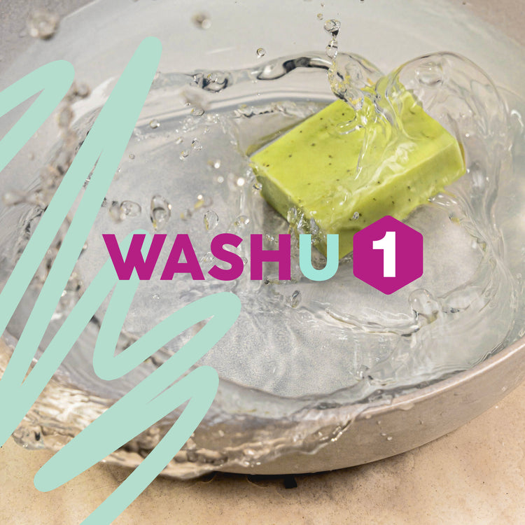 Green washu1 soap bar in a metal bowl with water splashing and 'WASHU' branding.